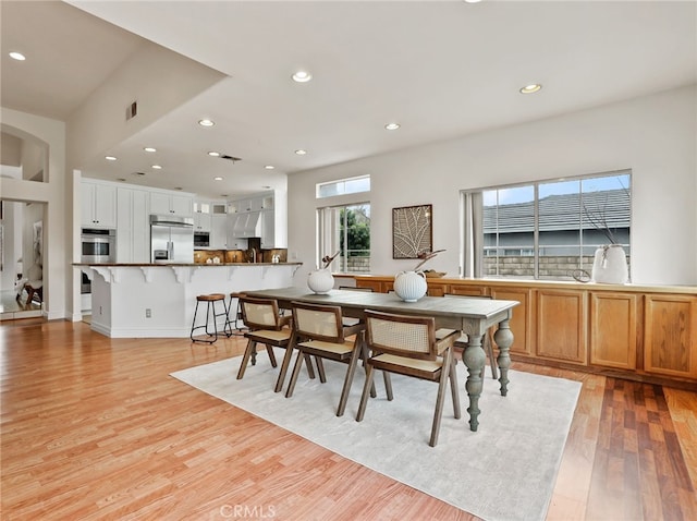 dining space with light hardwood / wood-style floors