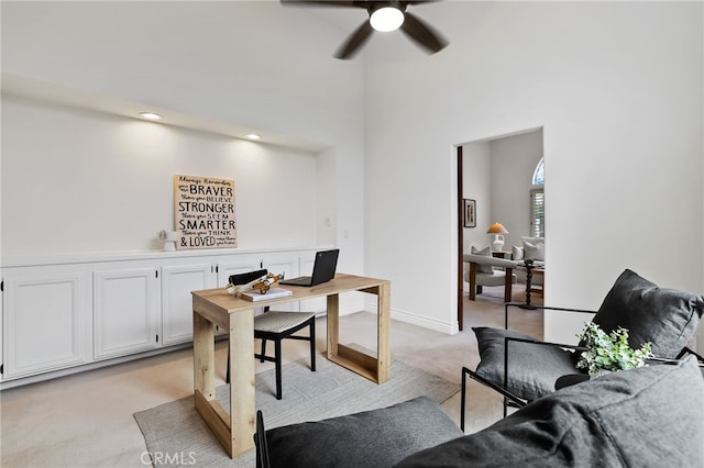 carpeted home office with ceiling fan