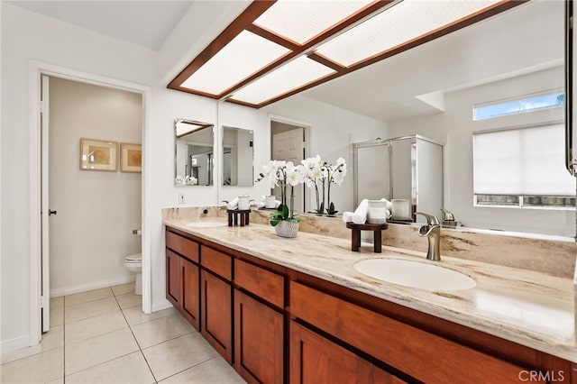 bathroom with walk in shower, vanity, toilet, and tile patterned flooring