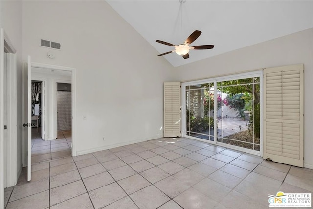 empty room with light tile patterned floors, high vaulted ceiling, and ceiling fan