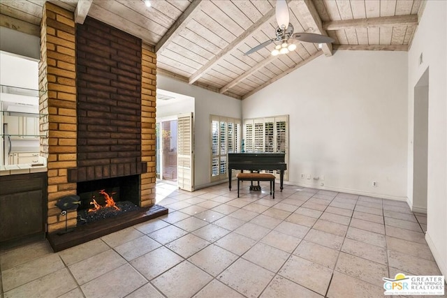 living room featuring light tile patterned floors, wood ceiling, a fireplace, and beamed ceiling