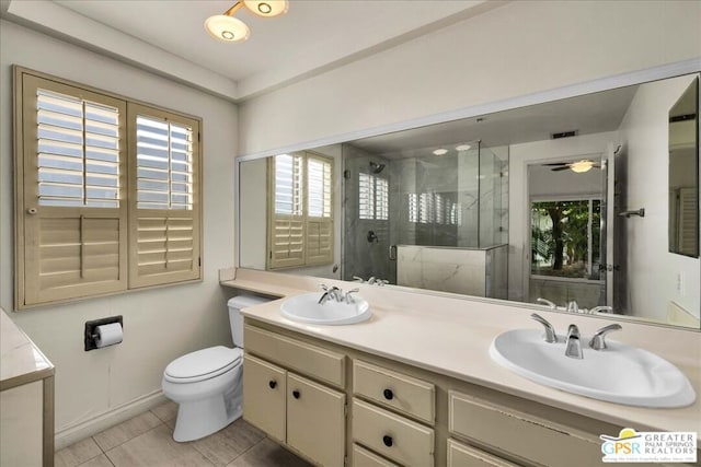 bathroom featuring vanity, tile patterned floors, toilet, and walk in shower