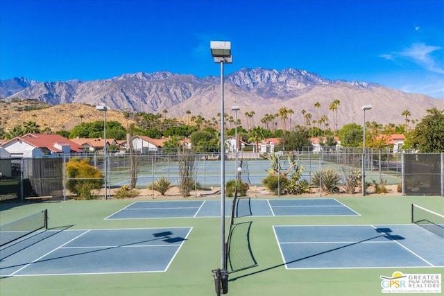 view of tennis court featuring a mountain view