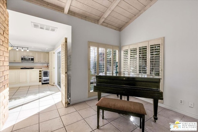 misc room with wine cooler, wooden ceiling, light tile patterned floors, and vaulted ceiling with beams