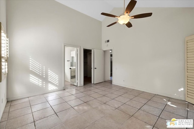 tiled empty room featuring high vaulted ceiling and ceiling fan