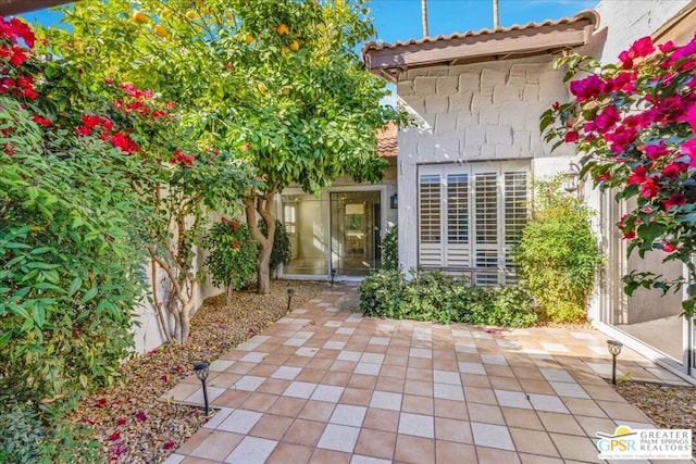 property entrance featuring a patio area