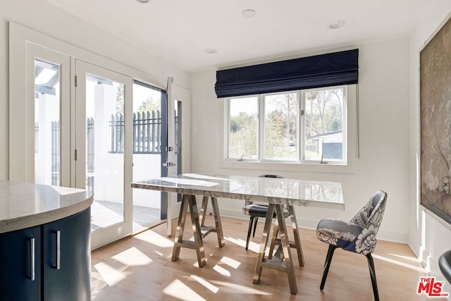 dining space with light hardwood / wood-style floors