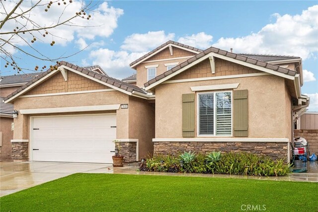 craftsman-style home with a garage and a front yard