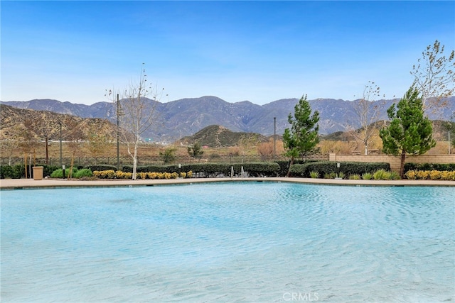 view of pool featuring fence and a mountain view