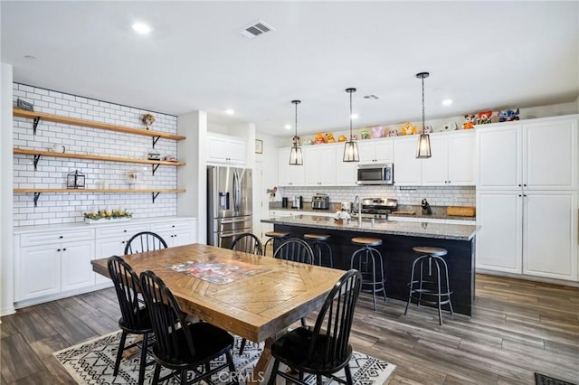 dining area with visible vents, dark wood-style flooring, and recessed lighting