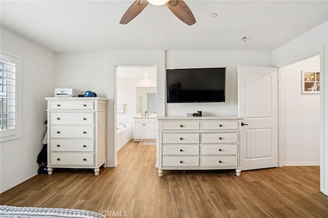 unfurnished bedroom with a ceiling fan, light wood-style flooring, and baseboards