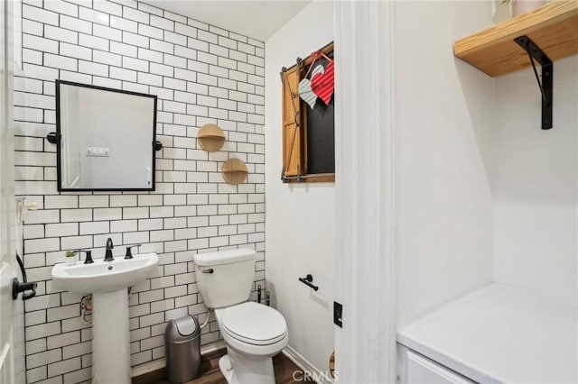 half bath featuring a sink and toilet