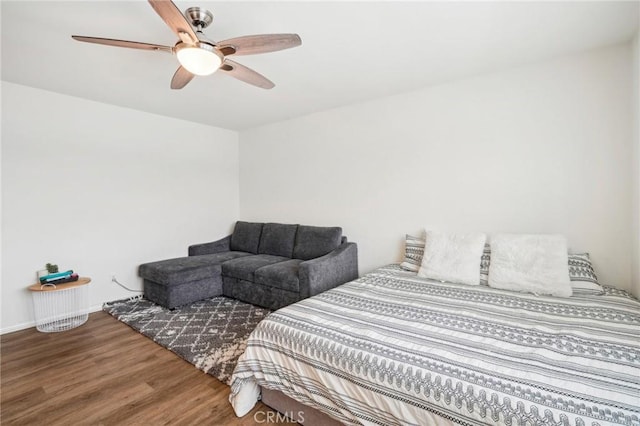 bedroom with a ceiling fan and wood finished floors