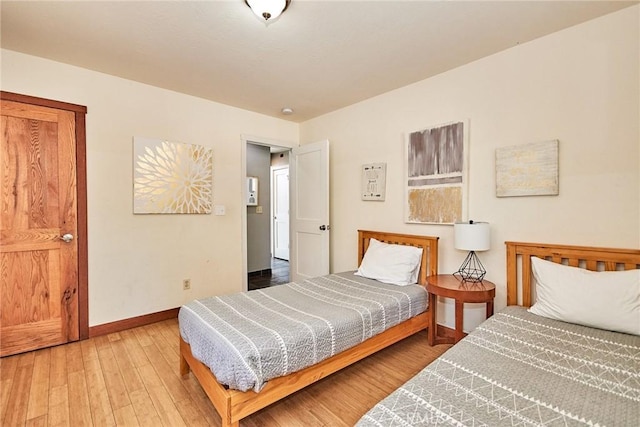 bedroom featuring hardwood / wood-style flooring and baseboards