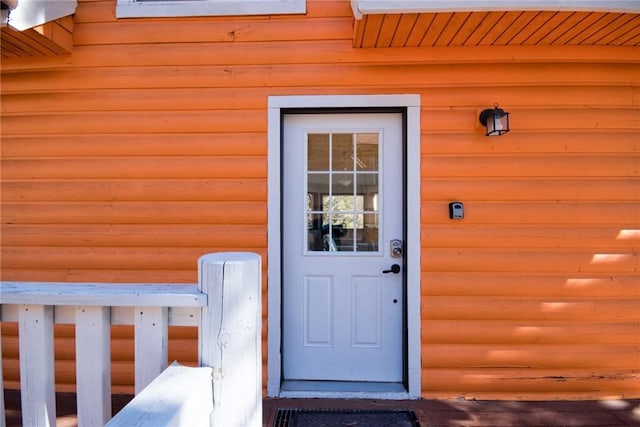 doorway to property with log veneer siding