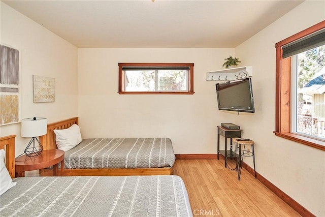 bedroom featuring light wood-type flooring and baseboards