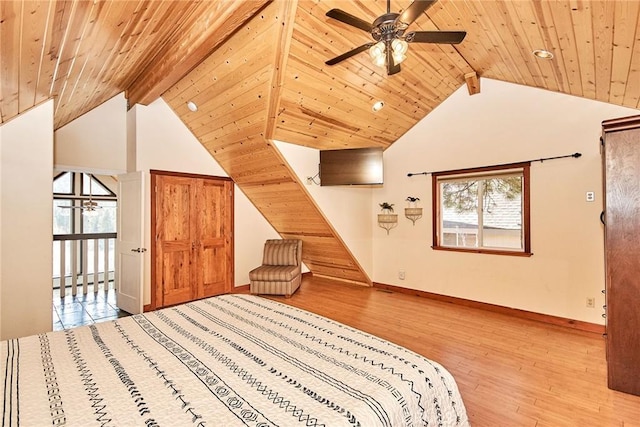 unfurnished bedroom featuring vaulted ceiling with beams, light wood-type flooring, wood ceiling, and baseboards