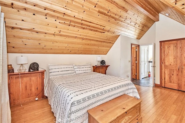 bedroom with vaulted ceiling, light wood finished floors, wooden ceiling, and baseboards