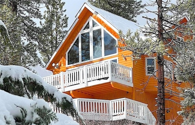 view of snow covered exterior with a balcony