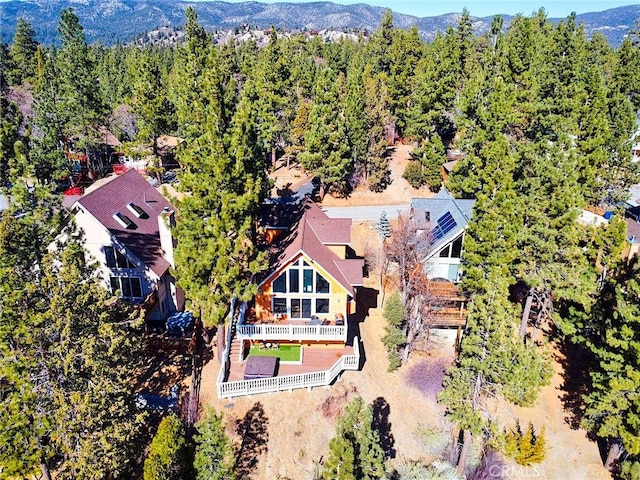 aerial view with a mountain view and a forest view