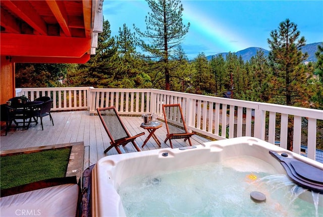 wooden terrace with a mountain view and a hot tub