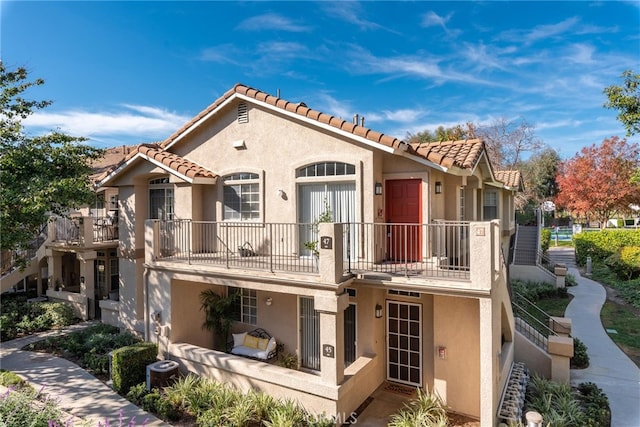 rear view of property with a balcony