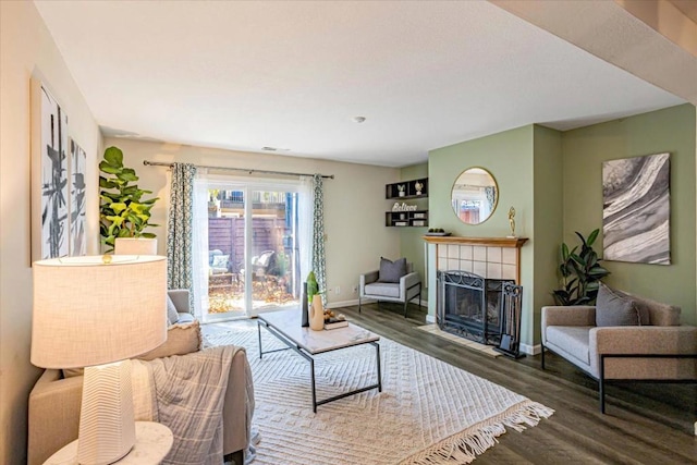 living room with hardwood / wood-style flooring and a fireplace