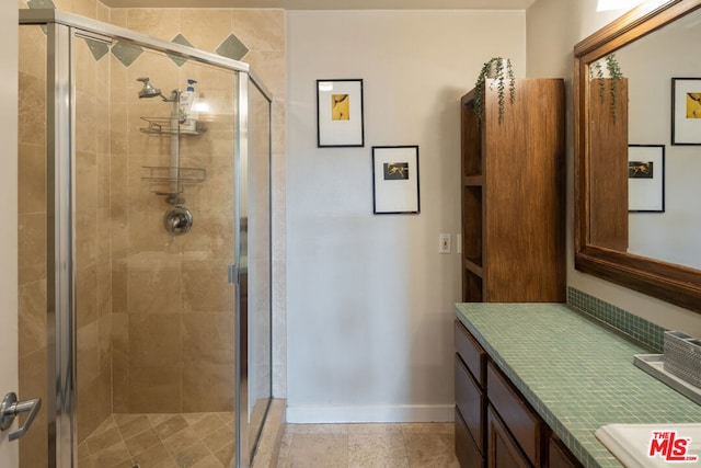 bathroom featuring vanity and a shower with shower door