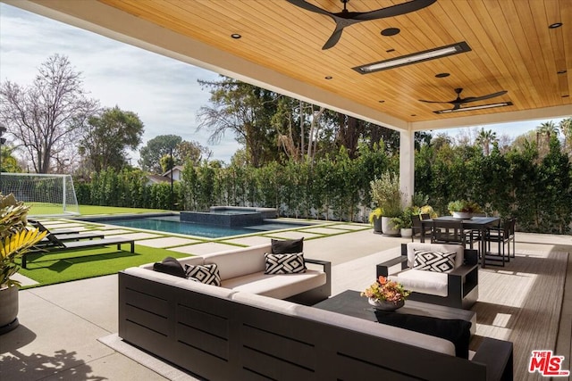 view of patio / terrace featuring a swimming pool with hot tub and an outdoor hangout area