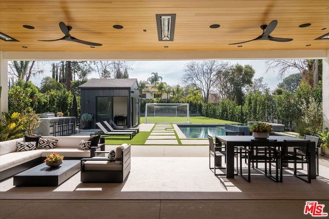 view of patio / terrace with an outdoor living space, an outdoor structure, an outdoor bar, and ceiling fan