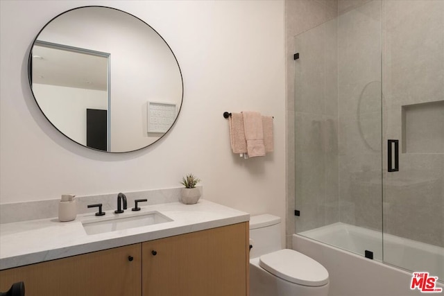 full bathroom with vanity, combined bath / shower with glass door, and toilet