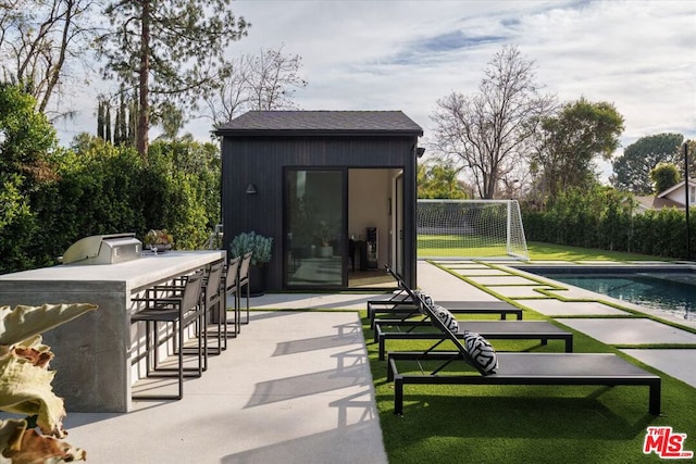 exterior space featuring an outdoor kitchen and exterior bar