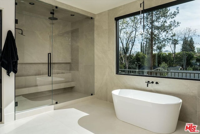 bathroom with plus walk in shower and tile walls