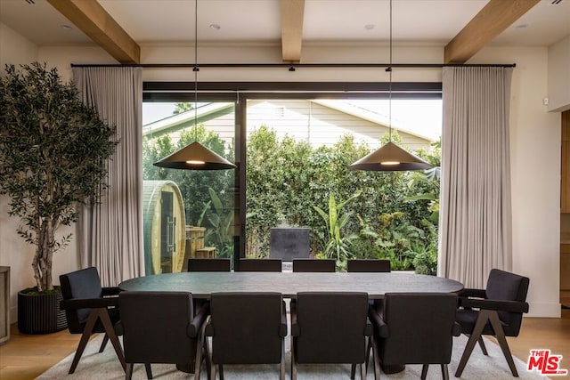 dining area featuring beam ceiling and light hardwood / wood-style floors