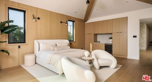 bedroom featuring lofted ceiling with beams, hardwood / wood-style floors, and wine cooler