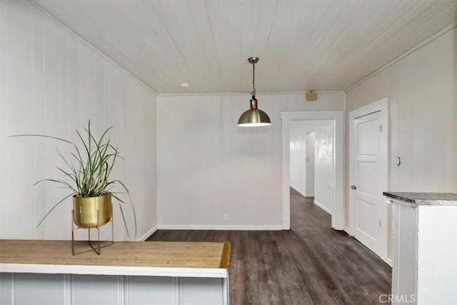 unfurnished dining area with dark wood-type flooring