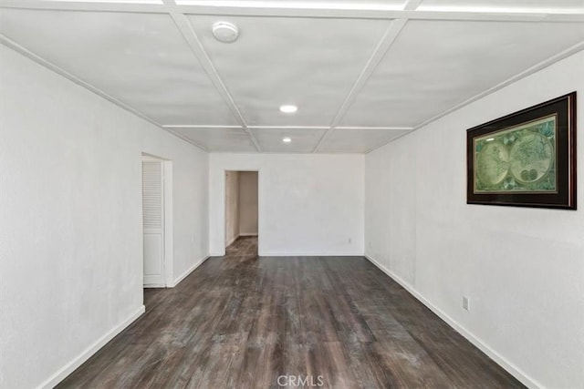 spare room featuring dark wood-type flooring