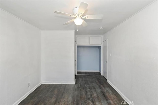 unfurnished bedroom with dark hardwood / wood-style flooring, a closet, and ceiling fan