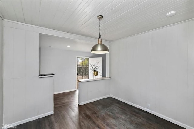 unfurnished dining area featuring dark hardwood / wood-style flooring