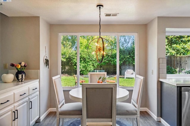 dining room with dark hardwood / wood-style floors and an inviting chandelier