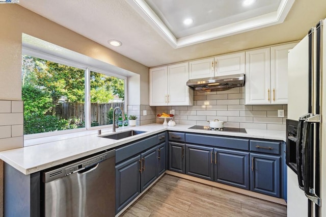 kitchen with sink, refrigerator with ice dispenser, dishwasher, black electric stovetop, and white cabinets