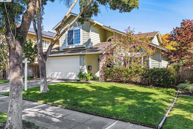 view of front of home with a garage and a front yard