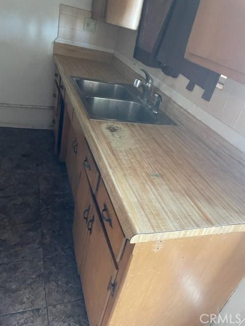kitchen featuring light countertops and a sink