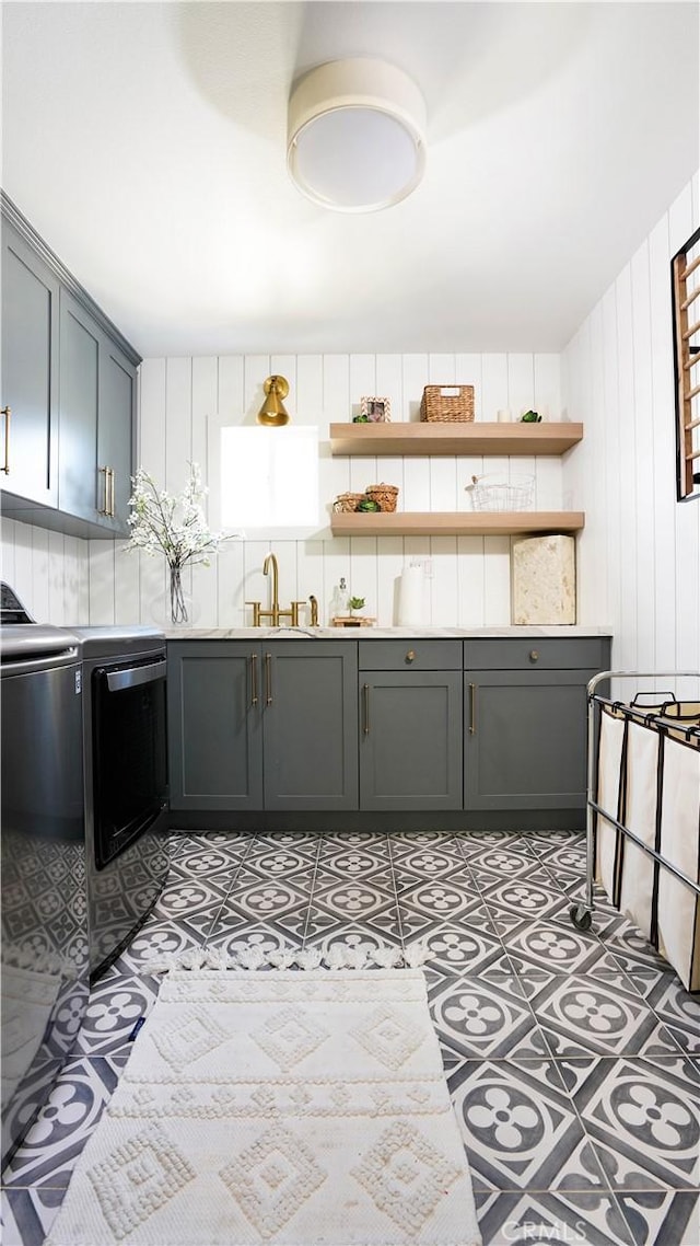 19 Basilica Pl, Ladera Ranch, CA 92694 - kitchen featuring open shelves, gray cabinets, washing machine and dryer, and wooden walls