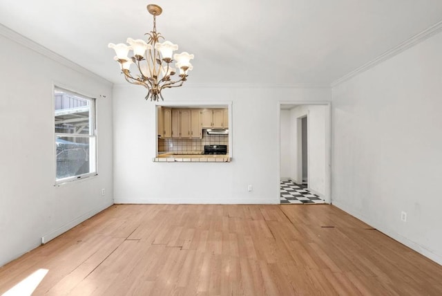 unfurnished living room with ornamental molding, a notable chandelier, and light hardwood / wood-style flooring