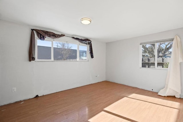 spare room with hardwood / wood-style floors