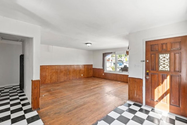 entryway featuring wood walls