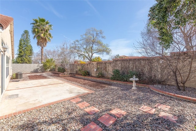 view of yard featuring a patio area, a fenced backyard, and central AC unit