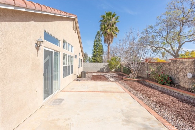 view of patio with a fenced backyard and cooling unit