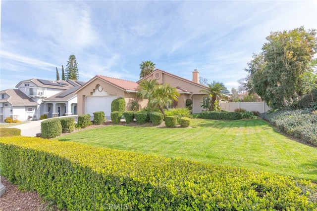 mediterranean / spanish-style home featuring an attached garage, fence, stucco siding, a chimney, and a front yard